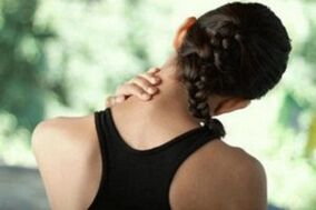 The girl is worried about cervical osteochondrose symptoms